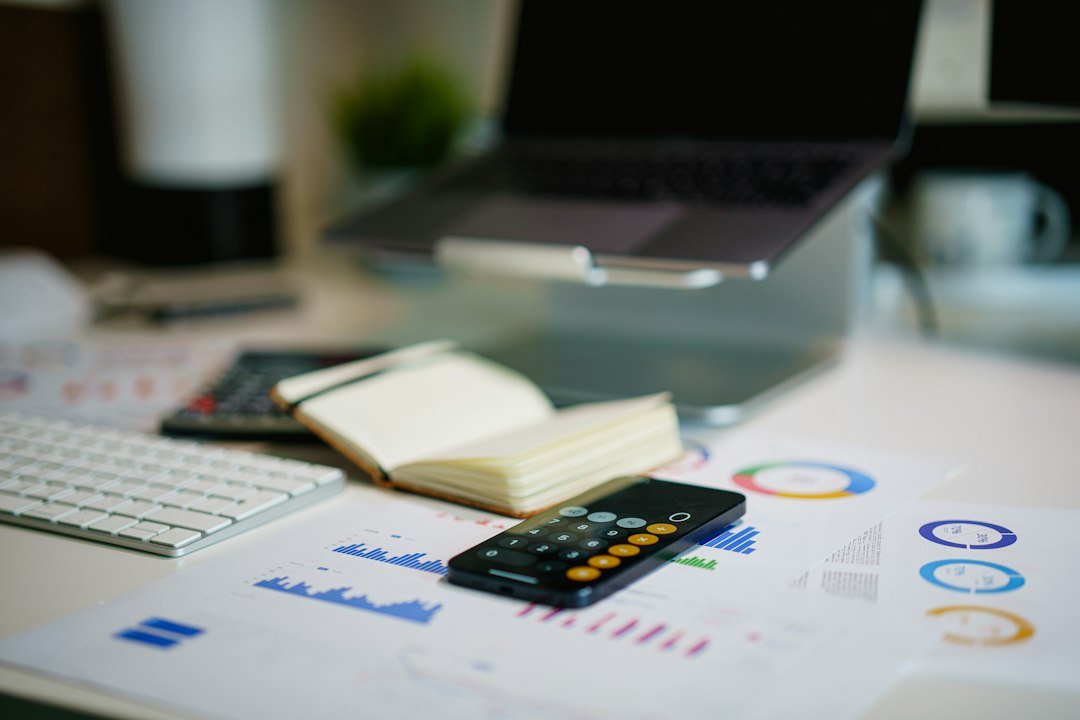 Accounting study desk with laptop, notebook and calculator